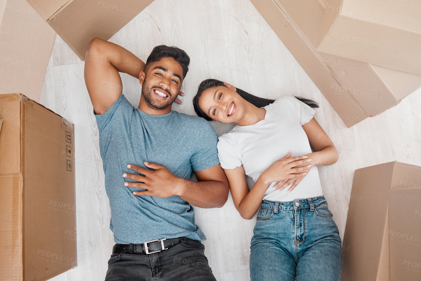 Buy stock photo Top view, home and couple with boxes, ground and relationship with property, living room and apartment. Portrait, happy man or woman on the floor, cardboard and property with investment and new house