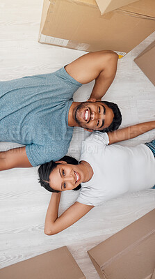 Buy stock photo Top view, home and couple with boxes, real estate and excited on the floor, living room and mortgage. Portrait, man and woman on the ground, cardboard and relationship with property and apartment