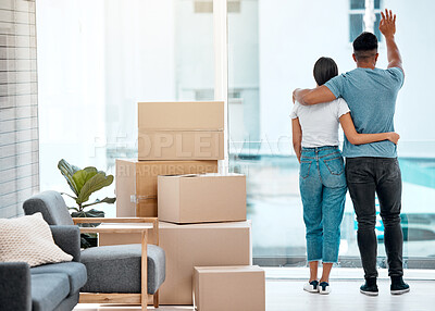 Buy stock photo Box, hug and back of couple in new home for property, apartment and real estate investment. Relationship, house and man and woman wave hello to neighbour, embrace and boxes for moving day by a window