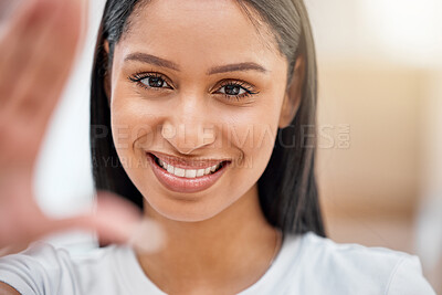 Buy stock photo Shot of an attractive young woman taking a selfie in her new home