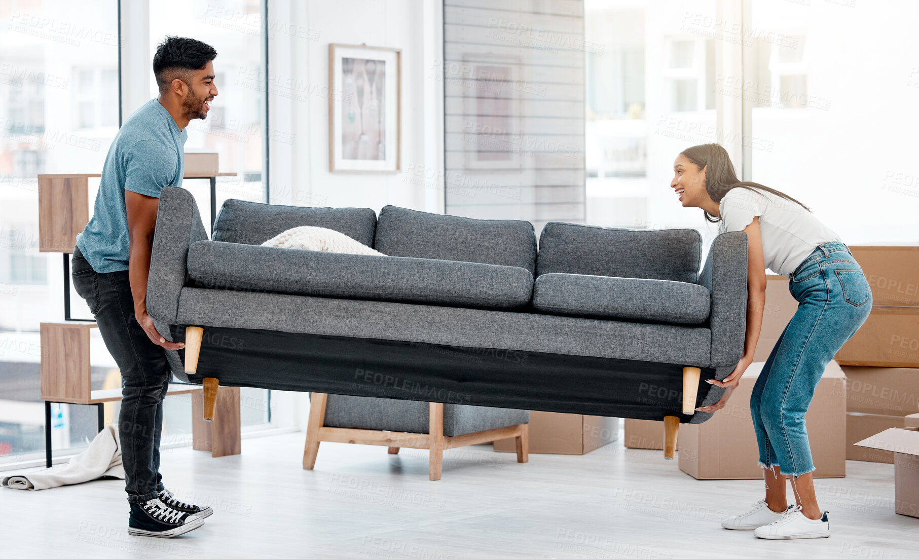 Buy stock photo Couple, people and moving sofa together in living room, apartment and excited for new home. Furniture, happy man and woman with heavy couch in property, unpacking and relocation inside the house 