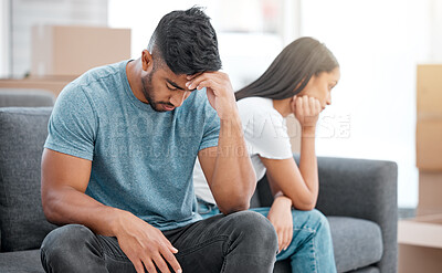 Buy stock photo Couple, fight and break up of man feeling depressed on living room sofa with relationship problem. Divorce talk, cheating anxiety and marriage crisis of young people on lounge couch at home thinking