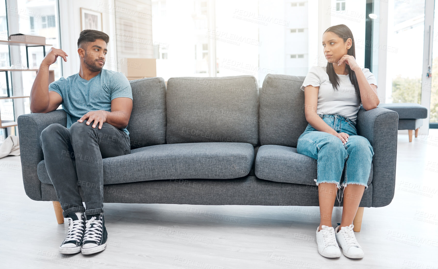 Buy stock photo Couple, fight and sofa distance feeling sad and depressed on living room with relationship problem. Divorce talk, cheating anxiety and marriage crisis of young people on a lounge couch at home 