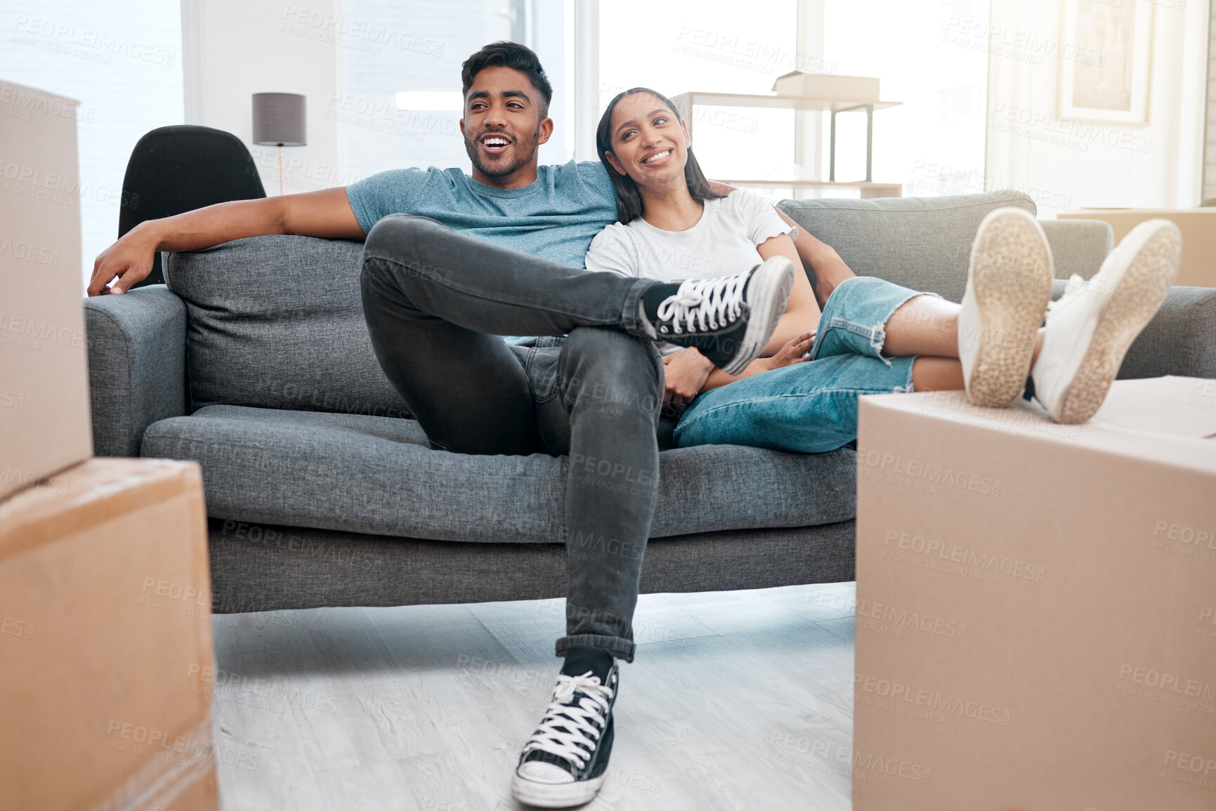 Buy stock photo Homeowners, relax and couple on a sofa, boxes and real estate with property, living room and moving in. Relationship, woman and man on a couch, love and mortgage with happiness, marriage or cardboard