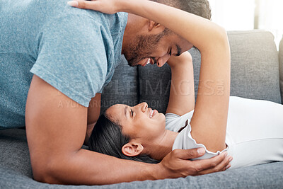 Buy stock photo Shot of a young couple bonding and sharing an intimate moment in their new home