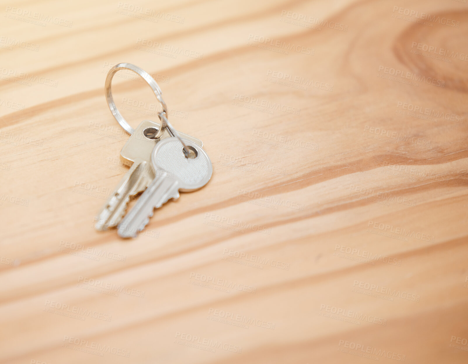 Buy stock photo Shot of house keys on a wooden table during the day