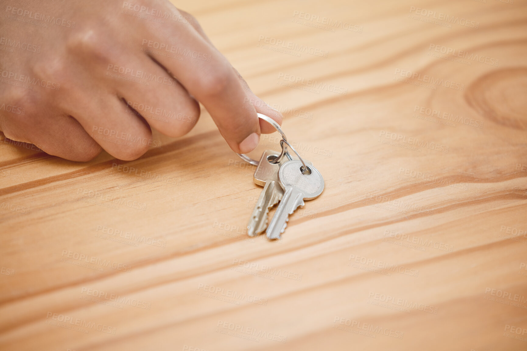 Buy stock photo Shot of an unrecognisable man taking a set of house keys off a wooden table