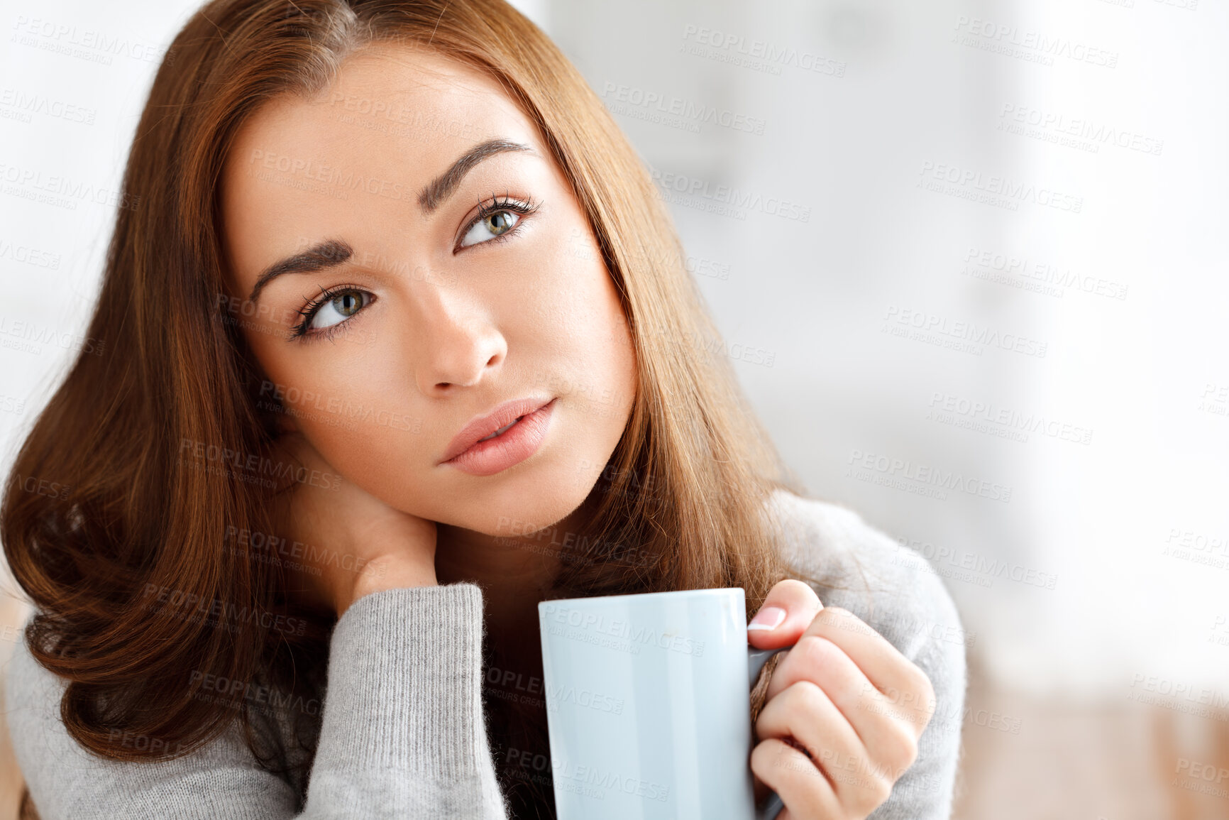 Buy stock photo Shot of a woman daydreaming while drinking coffee