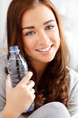 Buy stock photo Face, beauty and water with a happy woman and a drink bottle in her home and giving a smile. Relax, skincare and teeth and a portrait of a lovely young female with hydration for glowing skin