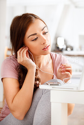 Buy stock photo Phone, music and woman streaming a podcast or radio while searching the internet on her laptop in a portrait. Young person relaxing at home listening to a new playlist on a audio subscription website