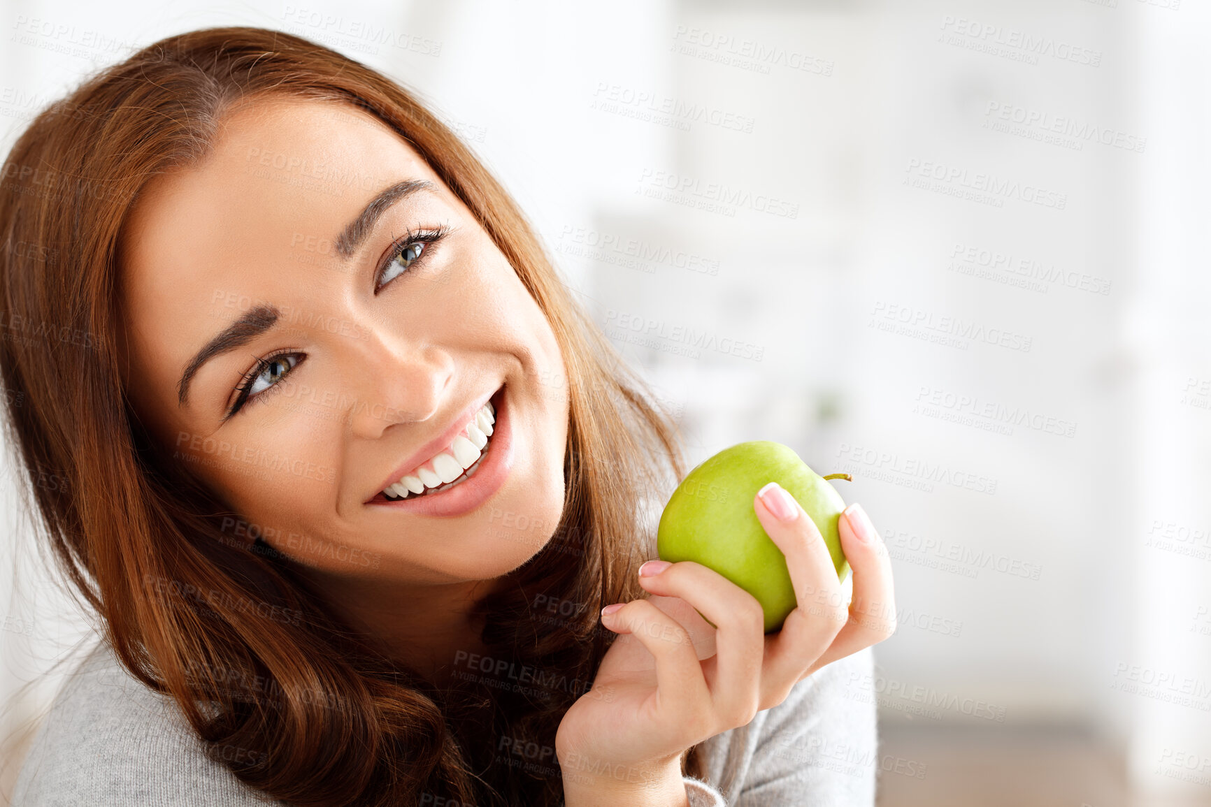 Buy stock photo Shot of a beautiful young woman enjoying an apple