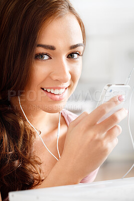 Buy stock photo Shot of a young woman listening to music on her cellphone