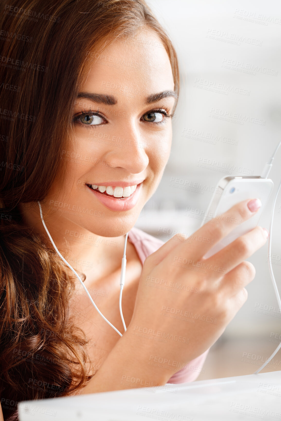 Buy stock photo Shot of a young woman listening to music on her cellphone