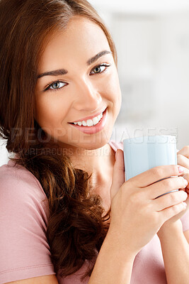 Buy stock photo Shot of a young woman enjoying a cup of coffee