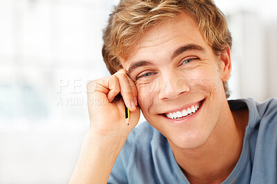 Buy stock photo Shot of a young male student taking a break from his studies