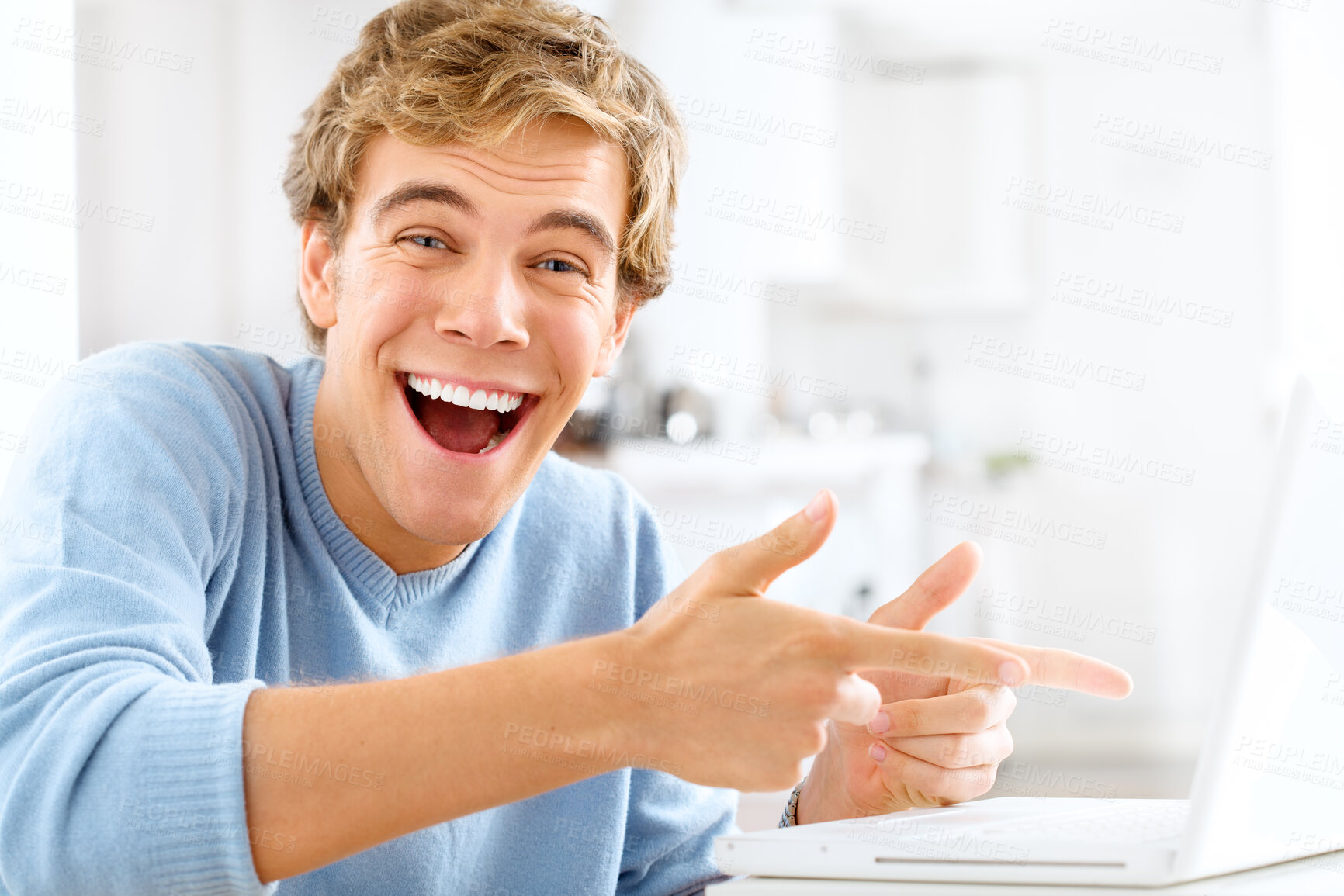 Buy stock photo Excited, pointing and portrait of man with laptop for good news, decision and success at table. Male person, smile and hands with gesture to technology for winning, opportunity or achievement at home