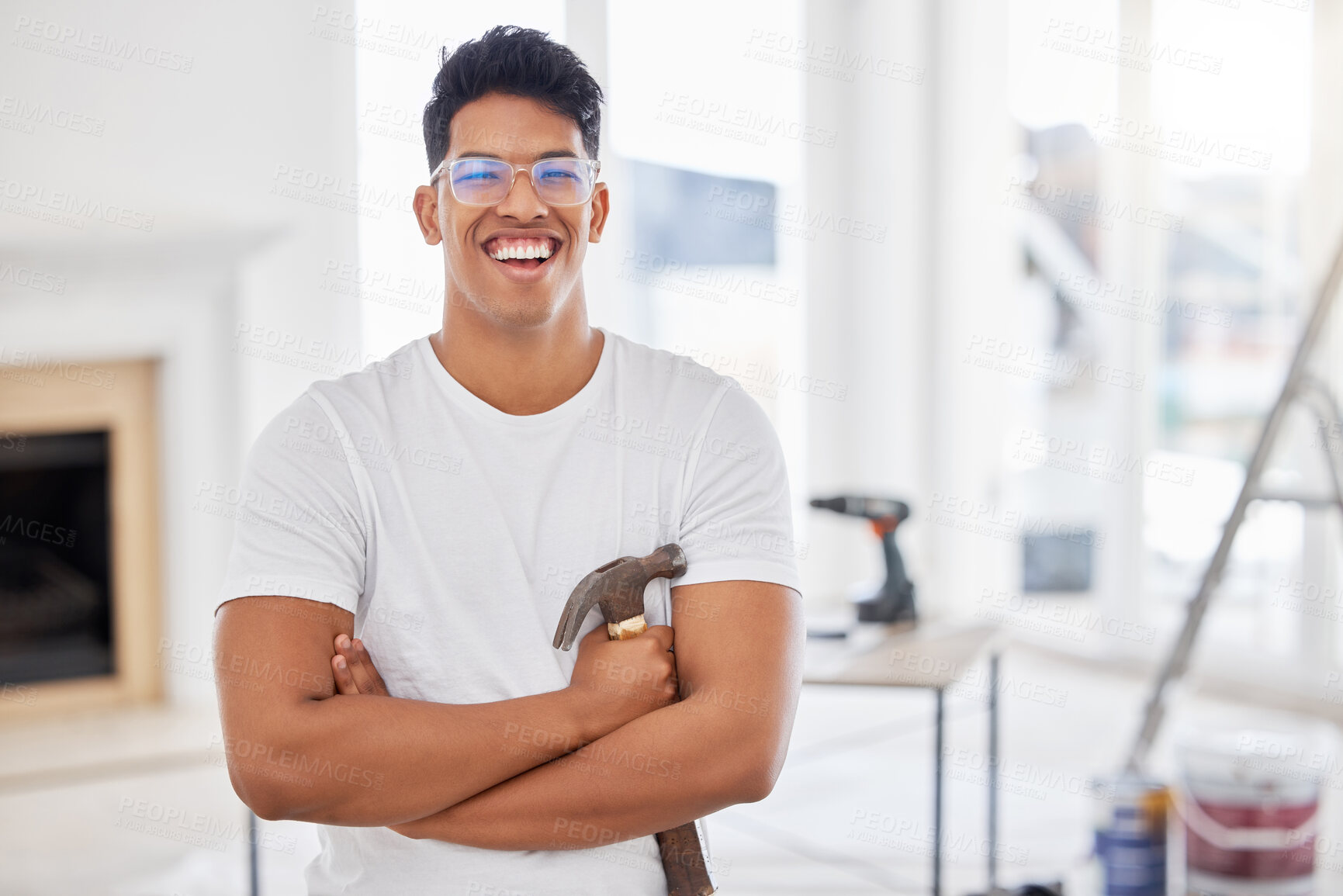 Buy stock photo Arms crossed, DIY and hammer with portrait of man in living room of home for construction or renovation. Goggles, safety and smile with happy person in apartment for development or improvement