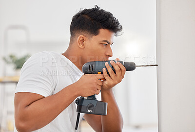 Buy stock photo Shot of a man using a cordless drill on a wall