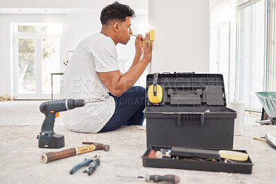 Buy stock photo Shot of a man using a spirit level while renovating a house