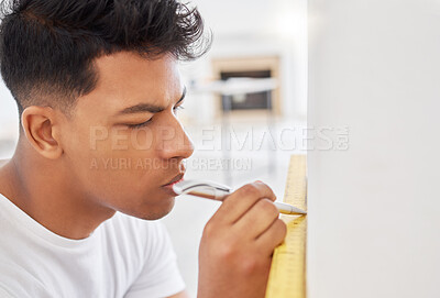 Buy stock photo Shot of a man using a spirit level while renovating a house