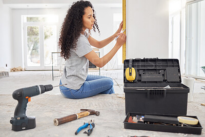 Buy stock photo Shot of a woman using a spirit level while renovating a house