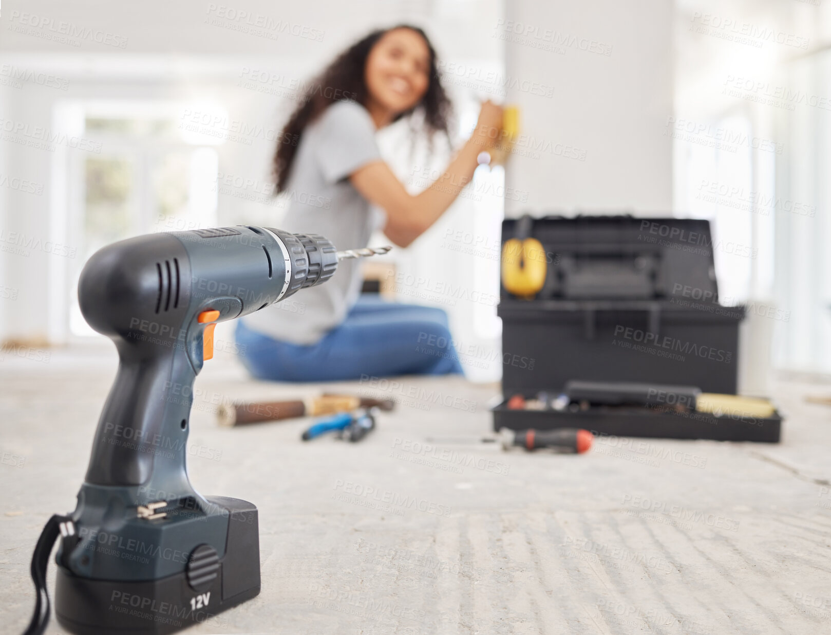 Buy stock photo Construction, drill and project management with DIY woman in home for decoration, maintenance or repairs. Blurry, design and power tools with person in apartment for building, improvement or remodel