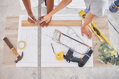 Buy stock photo Shot of two people discussing a blueprint