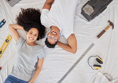 Buy stock photo Shot of a young couple renovating their house together