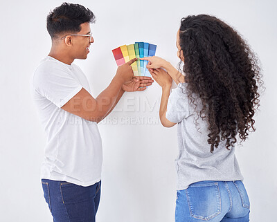 Buy stock photo Shot of a young couple looking at color swatches while busy renovating a house