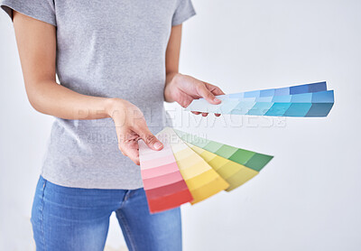 Buy stock photo Shot of an unrecognizable woman holding color swatches while standing against a white background