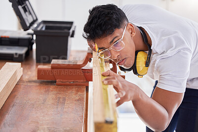 Buy stock photo Cropped shot of a carpenter doing measurements on wood