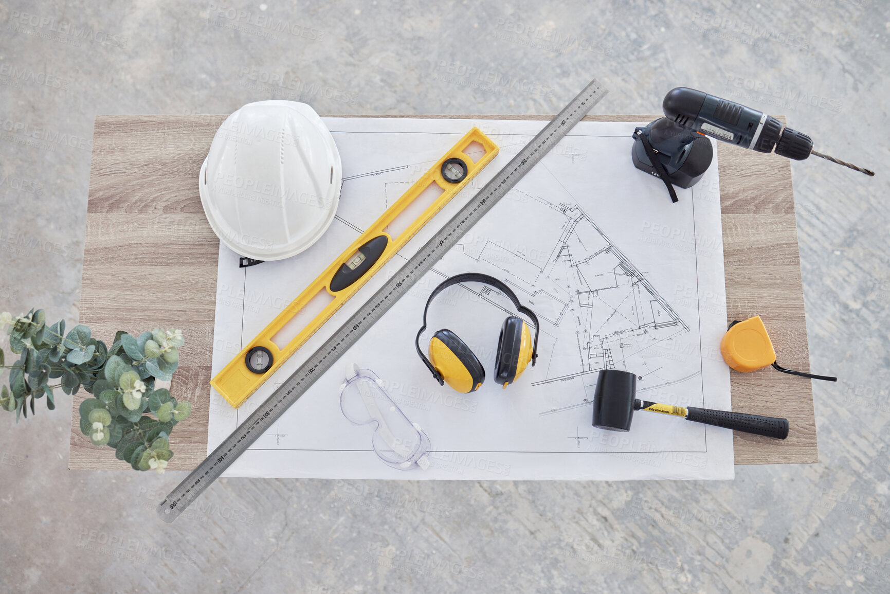 Buy stock photo High angle shot of building plans and equipment on a table in an empty living room during the day