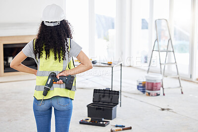 Buy stock photo Shot of an unrecognisable contractor standing alone and holding a power drill in a room during the day