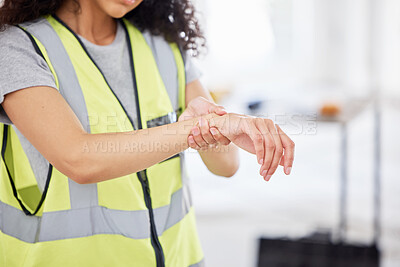Buy stock photo Cropped shot of an unrecognisable contractor standing alone inside and suffering from a wrist injury