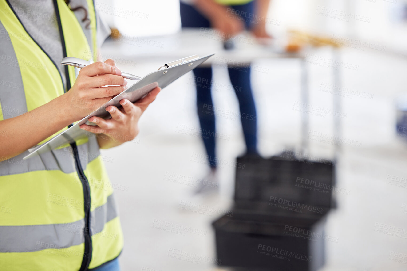 Buy stock photo Cropped shot of an unrecognisable contractor standing inside and using a clipboard