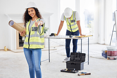Buy stock photo Shot of an attractive young contractor standing inside and showing a thumbs up