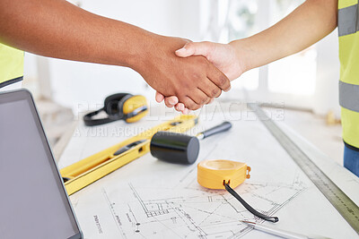 Buy stock photo Cropped shot of two unrecognisable contractors standing inside together and shaking hands