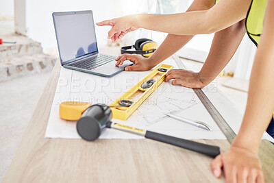 Buy stock photo Cropped shot of two unrecognisable contractors standing inside together and using a laptop while planning