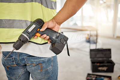 Buy stock photo Construction, handyman and drill in hand of a man for maintenance or carpenter work. Back of male engineer, constructor or contractor worker with electric power tools at building site for renovation