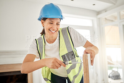 Buy stock photo Shot of an attractive young construction worker standing alone and using a screwdriver