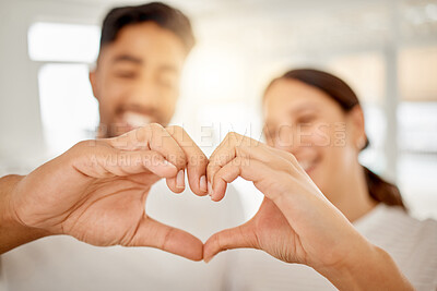 Buy stock photo Shot of an unrecognisable couple standing together and making a heart shaped gesture