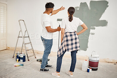 Buy stock photo Couple, painting and DIY in living room for home decor, creativity and bonding at wall. Man, woman and together in lounge for interior design, explanation and inspiration with color in apartment