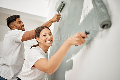 Buy stock photo Shot of a young couple painting a room together