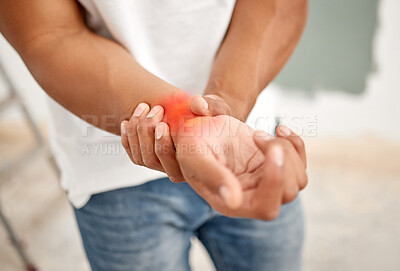 Buy stock photo Cropped shot of an unrecognizable man experiencing discomfort in his wrist