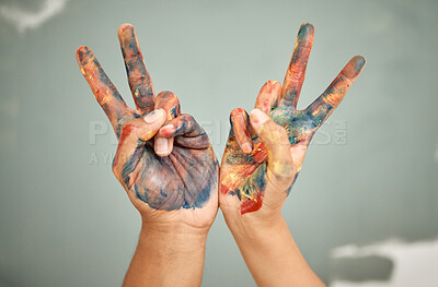 Buy stock photo Cropped shot of two people showing the peace sign while painting