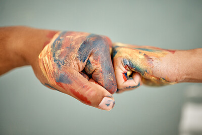 Buy stock photo Shot of an unrecognizable couple sharing a fist bump while painting