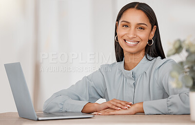 Buy stock photo Shot of a young businesswoman using a laptop in an office at work