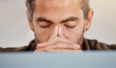 Buy stock photo Shot of a young businessman suffering from a headache at work