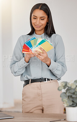 Buy stock photo Shot of a young woman holding different colour swatches while renovating her house