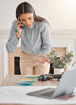 Buy stock photo Shot of a young female interior design looking at colour swatches while on the phone